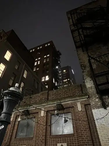 Urban grit meets night's soft glow.